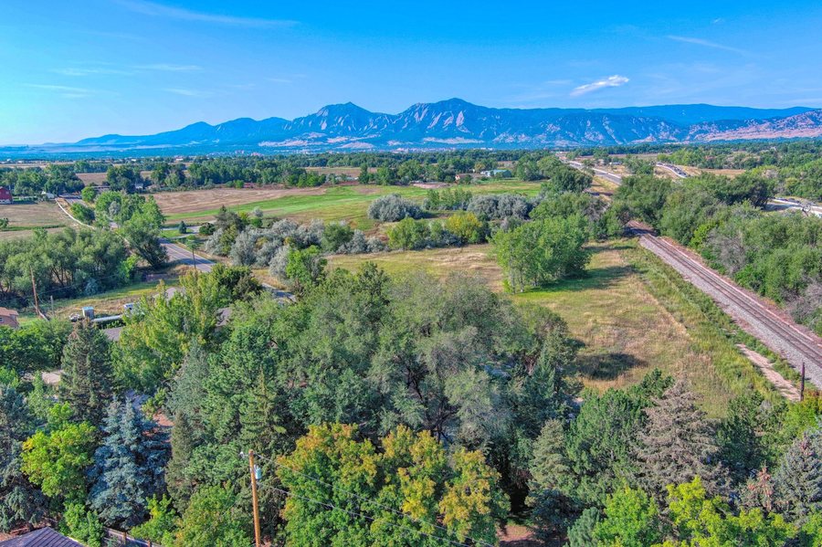 Aerial view of Boulder County residential land and mountain backdrop