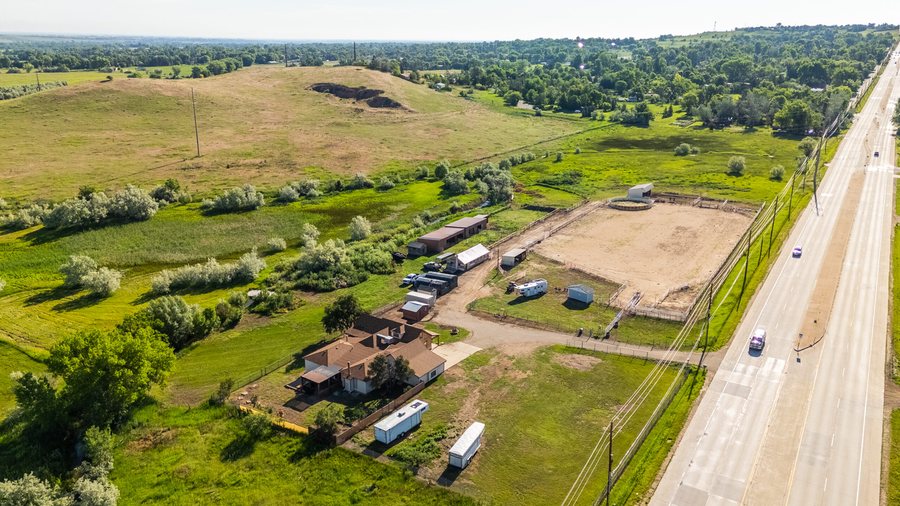 Aerial view of Boulder County ranch land and outbuildings on a Kathryn Pancost listing